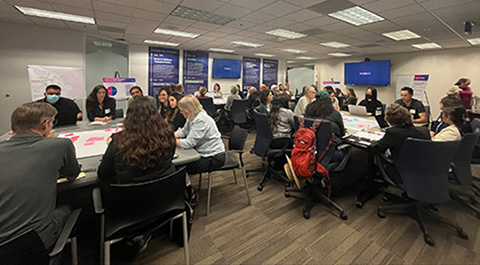 A large group of people sitting at tables.