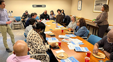 A group of people sitting around a table.