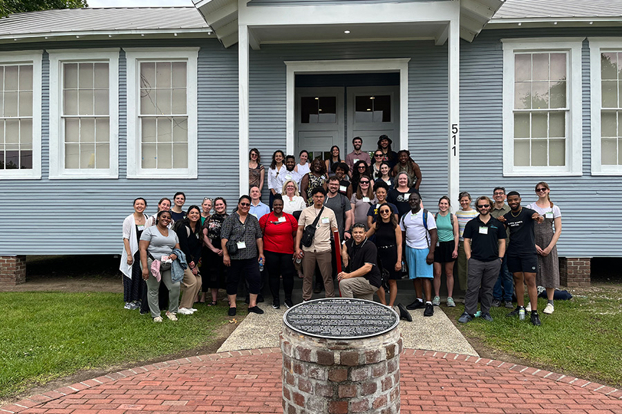 A group photo in front of a house.