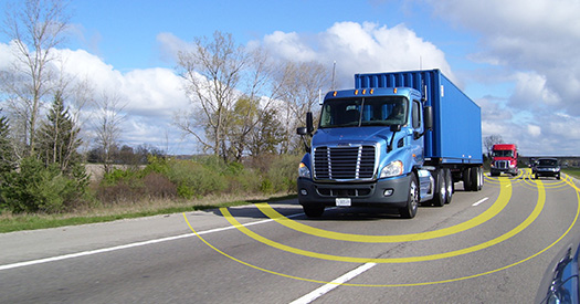 Photo of a blue semi-truck with yellow concentric rings around it, representing connectivity with other vehicles.