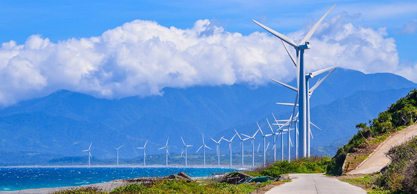 Wind turbines line ocean edge