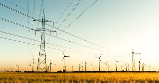 Wind turbines in a field at sunset