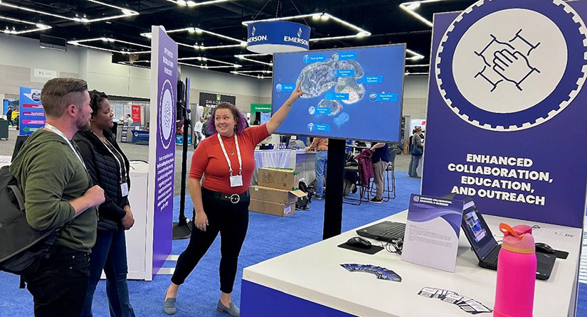 Person pointing at screen inside tradeshow booth