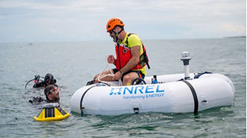 NREL researcher on a wave energy converter