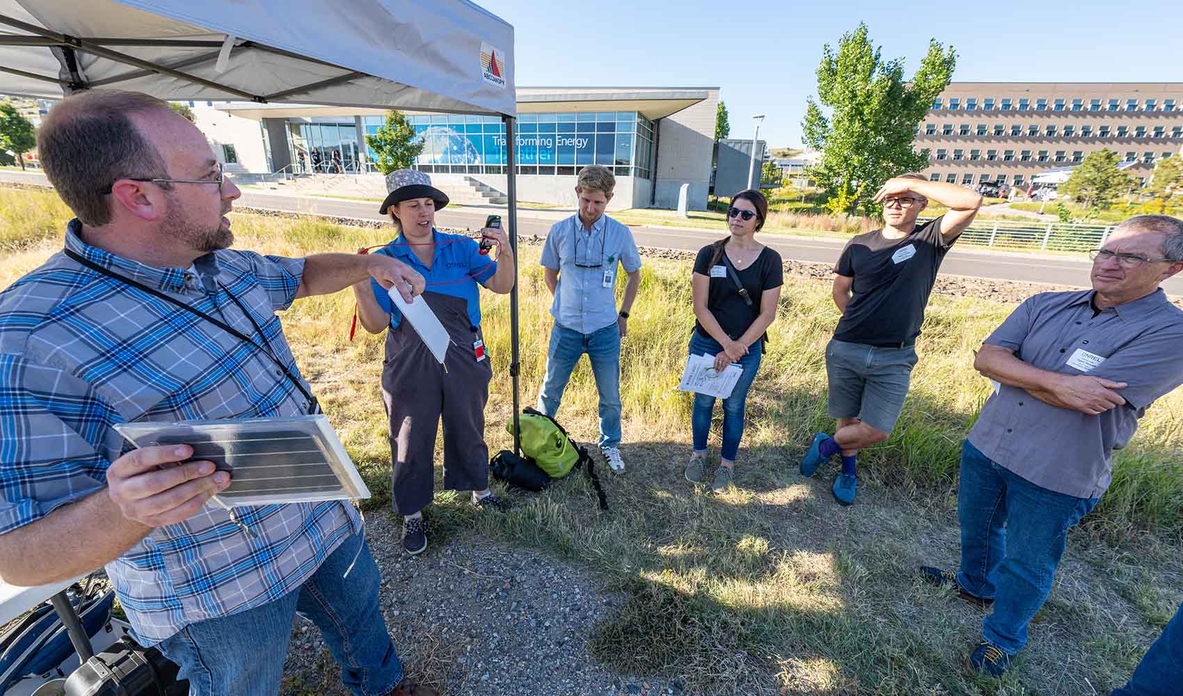 A group listens to a tour guide at the National Renewable Energy Laboratory