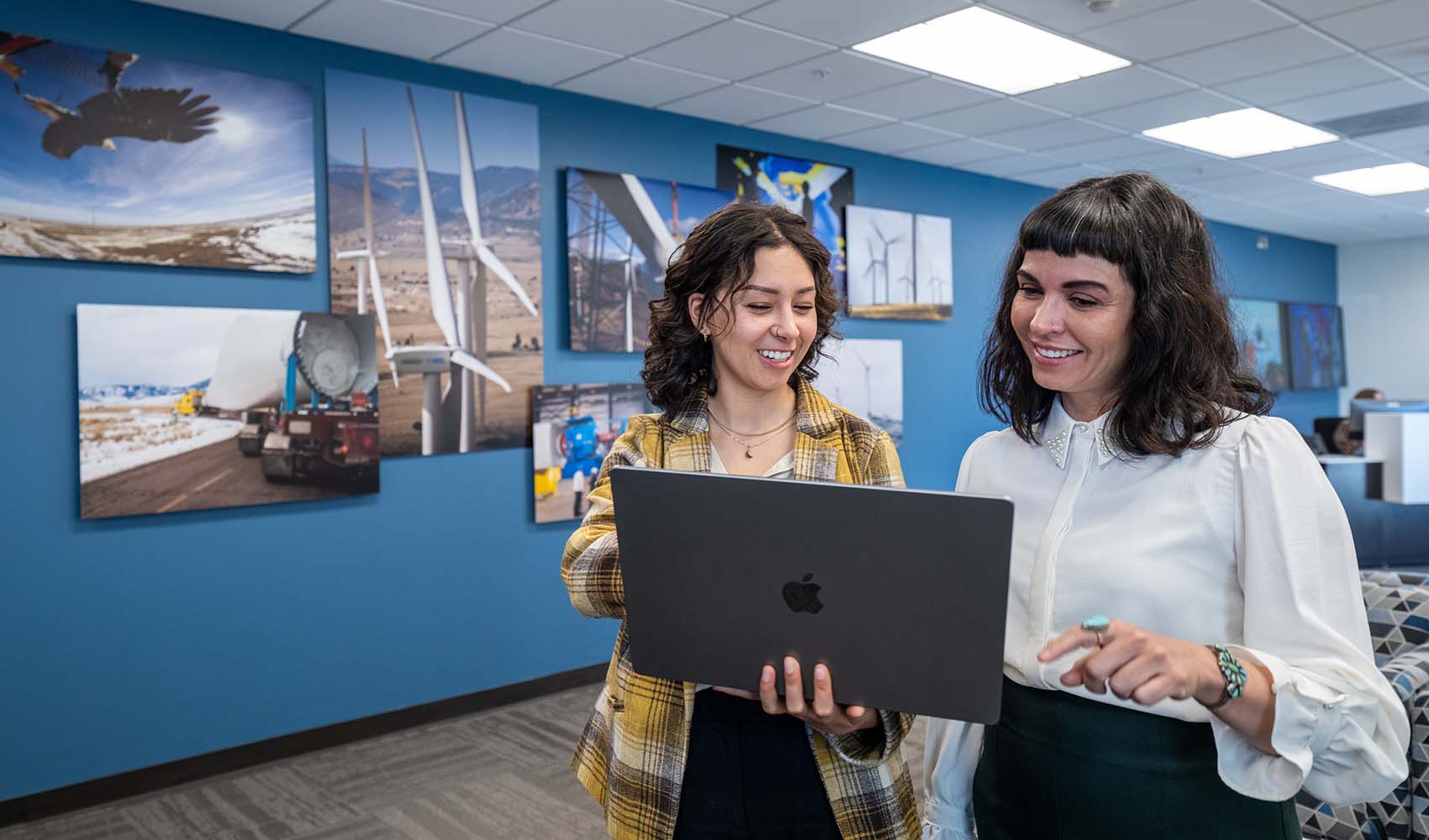 Two people looking at a laptop